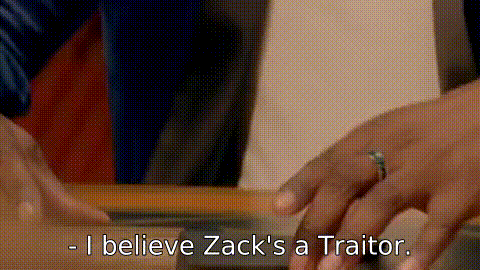 A contestant turning their slate to reveal “ZACK” written upside-down