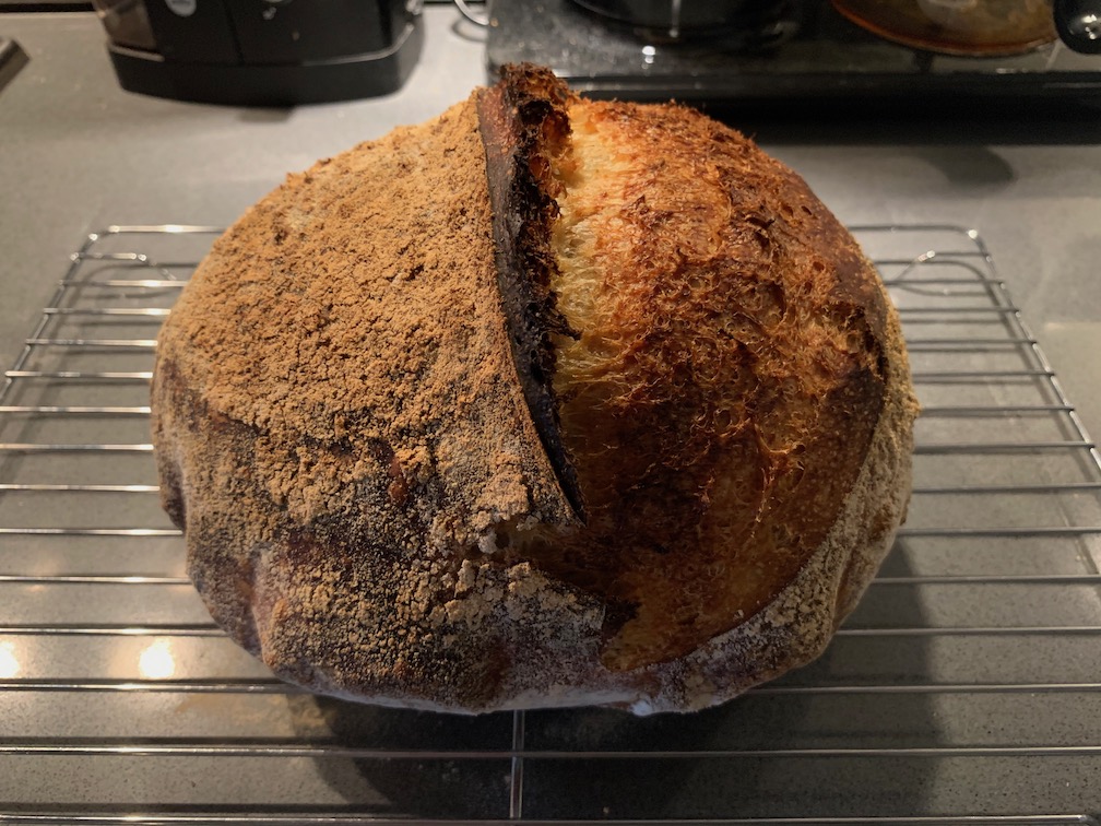 A large, round loaf of sourdough bread